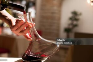 Waiter pouring the wine in a glass