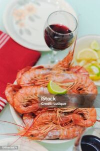 Fresh boiled prawns with lime and glasses of wine Dinner Red wine